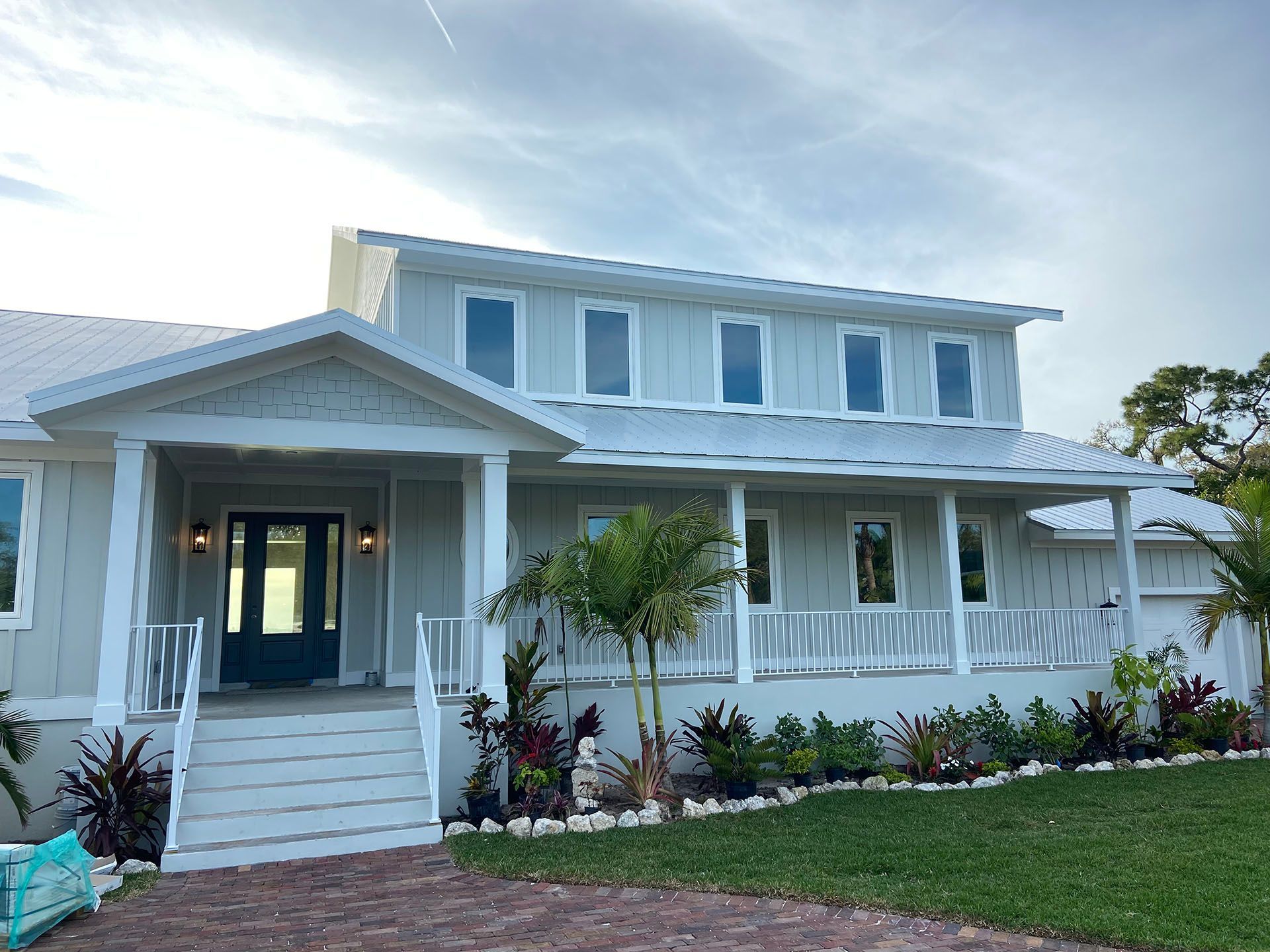 A large white house with a blue door and porch