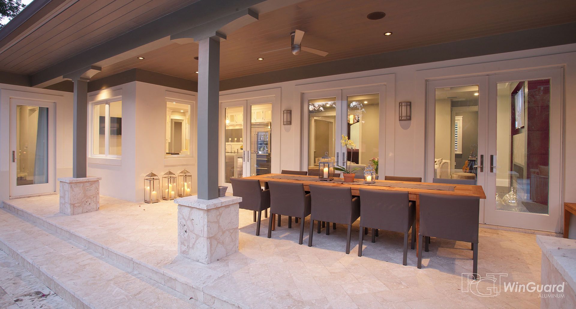 A large patio with a dining table and chairs