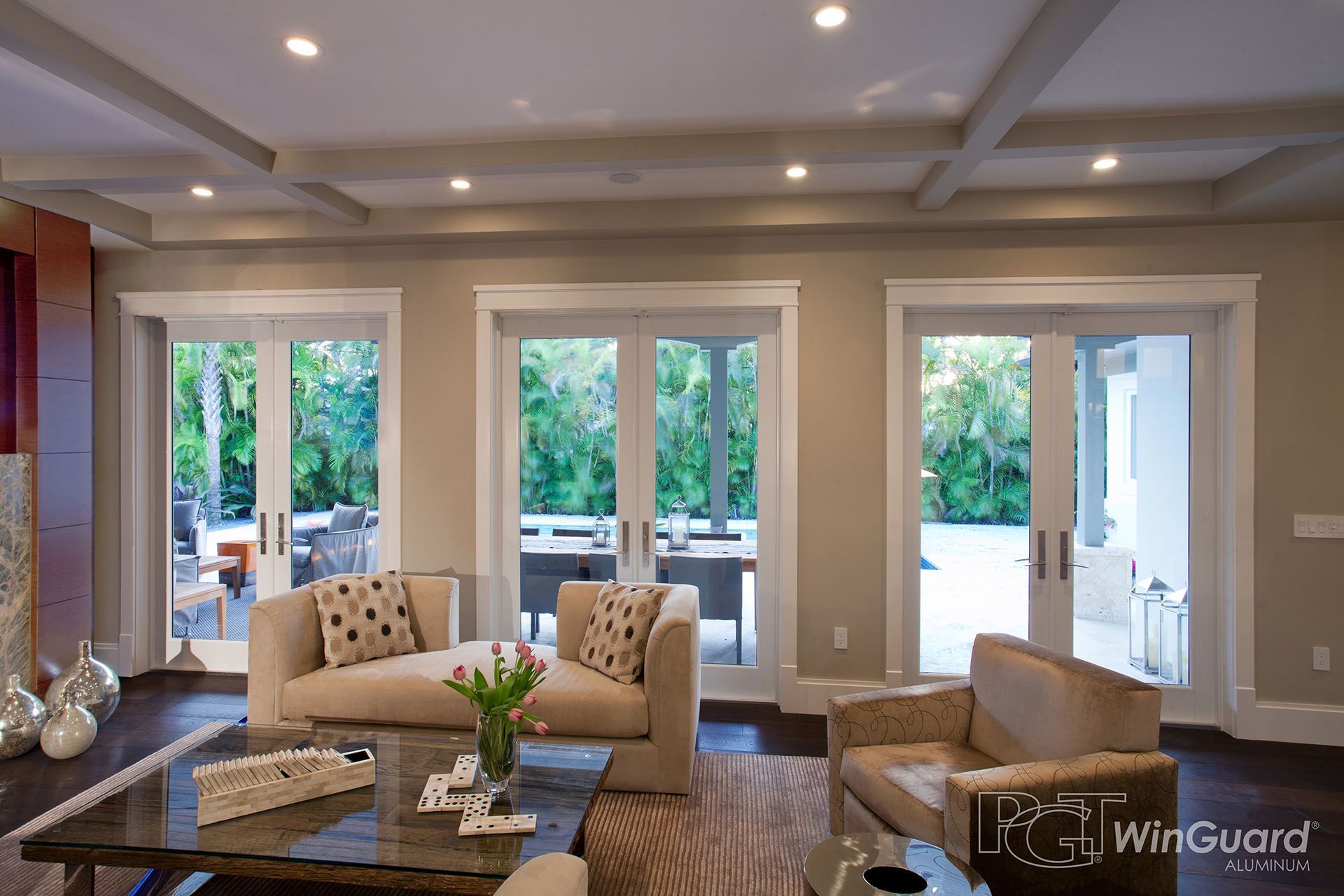 A living room with a lot of windows and a wingguard logo