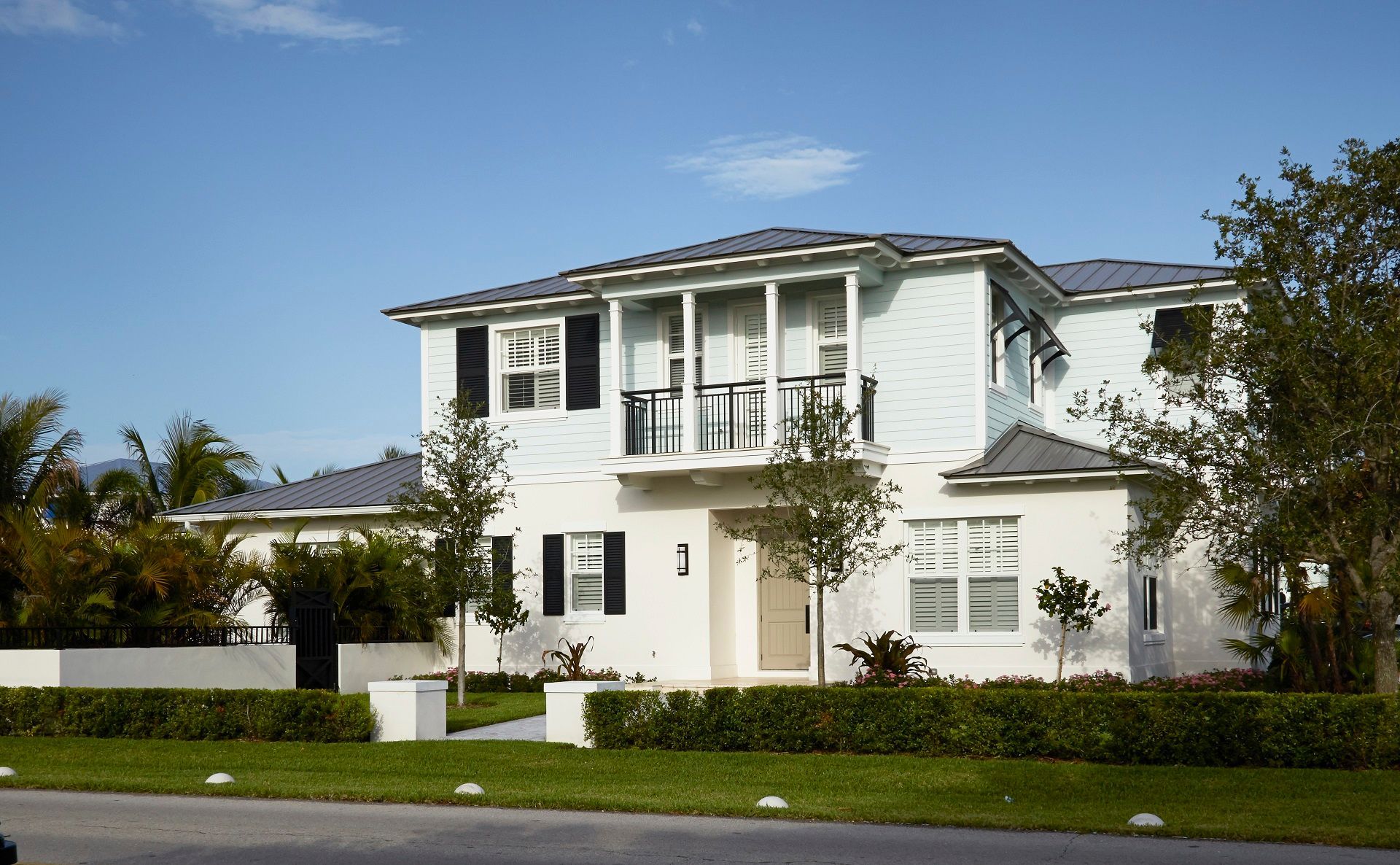 A large white house with black shutters on the windows