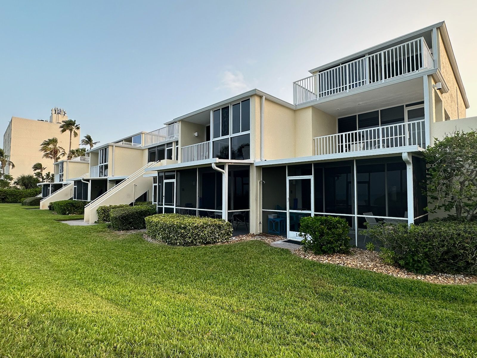 A row of apartment buildings with a lot of windows and balconies.
