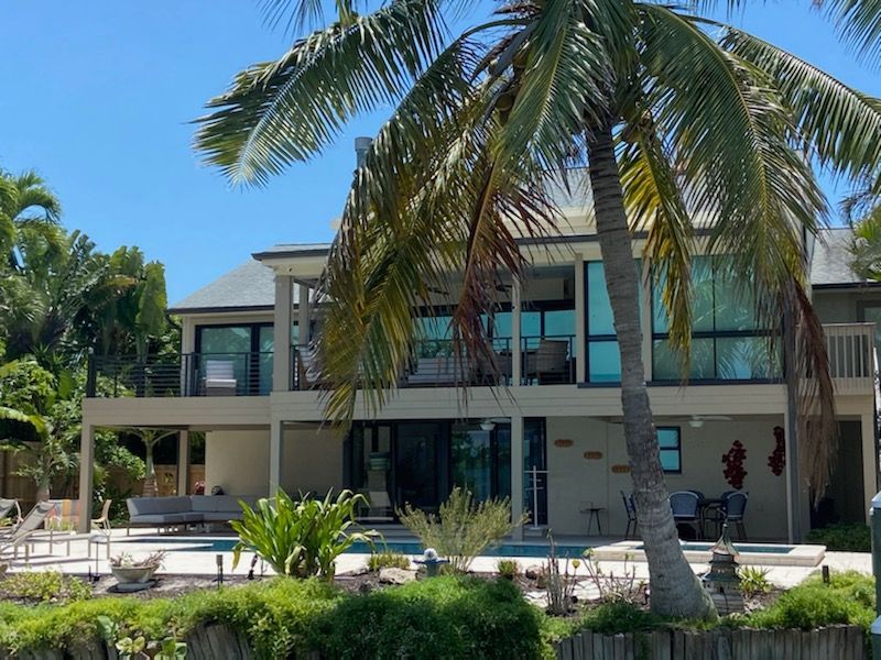 A large white house with black shutters on the windows