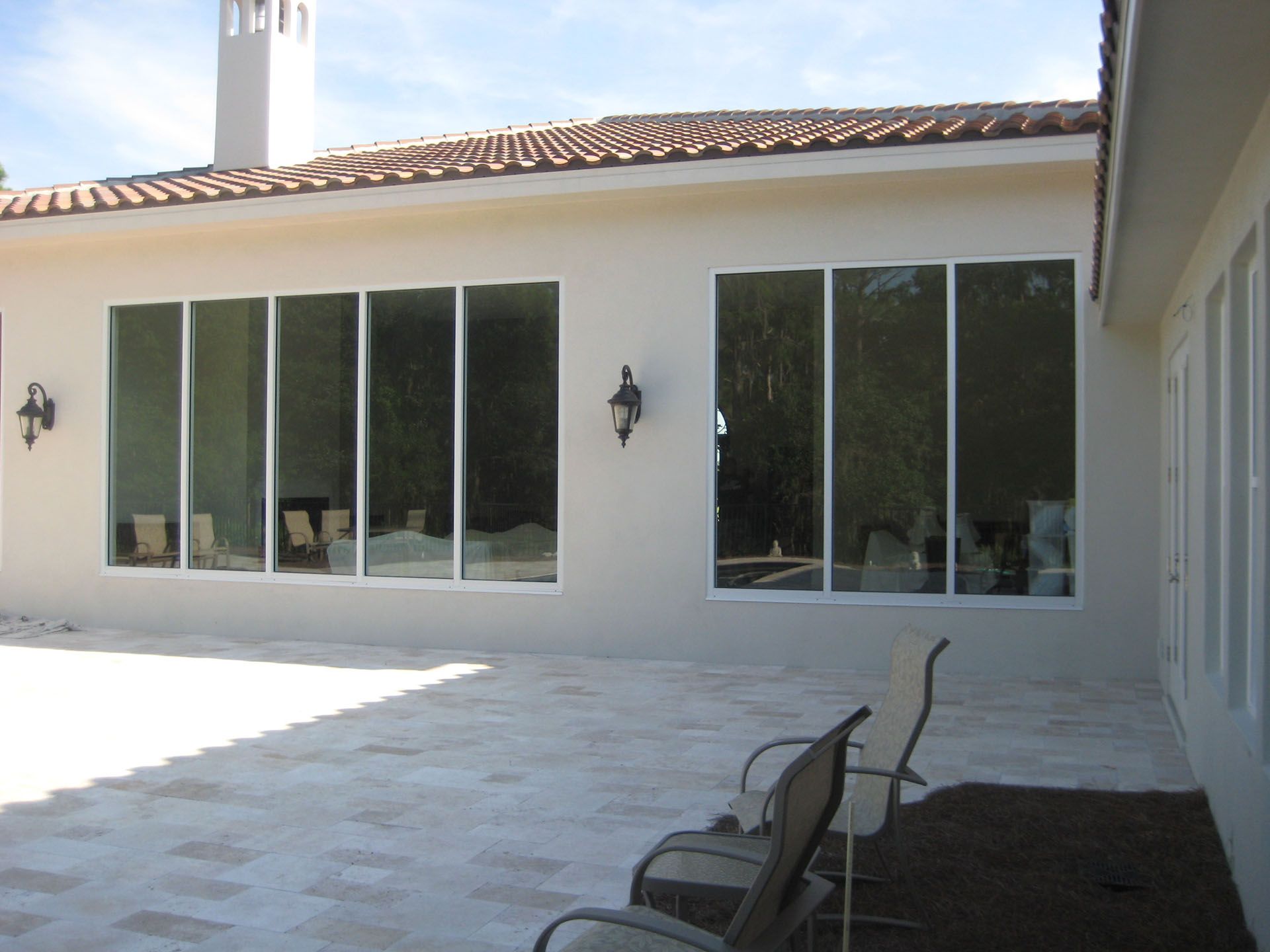 A house with a lot of windows and chairs