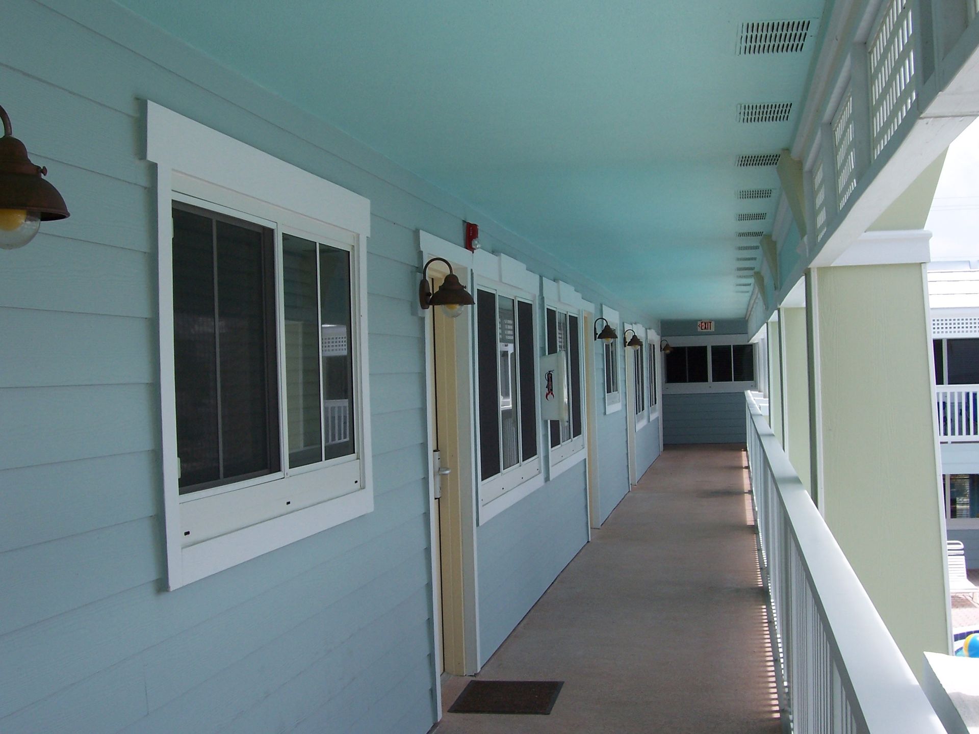 A long hallway with lots of windows and doors