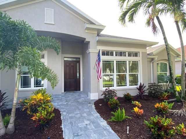 A house with a palm tree in front of it