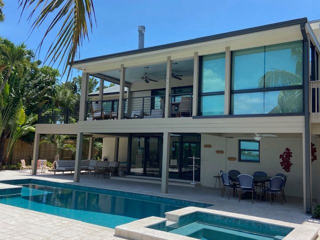 A large house with a large swimming pool in front of it