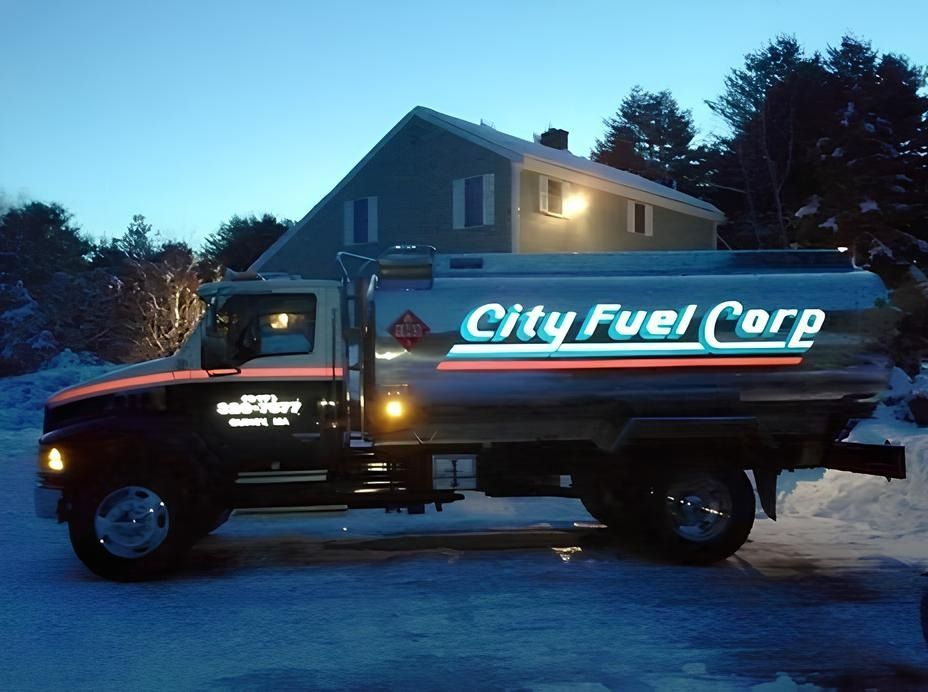 City Fuel Corp fuel truck parked at dusk in a driveway beside a house