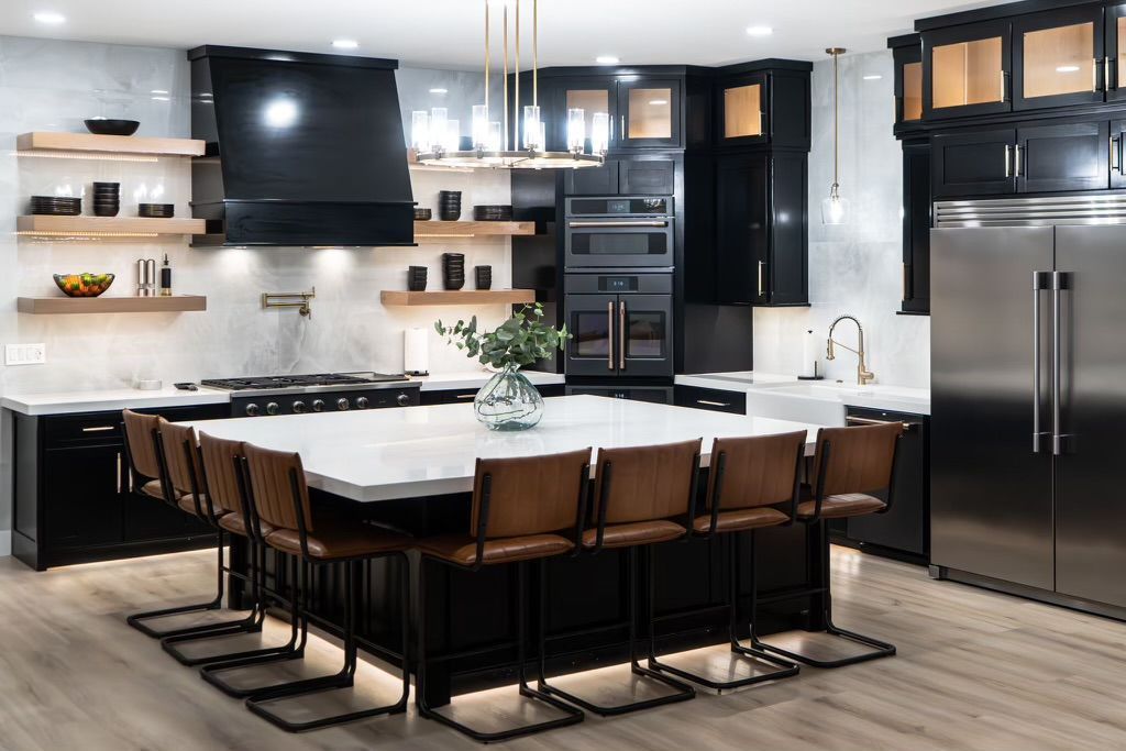 A kitchen with a large island and stainless steel appliances.