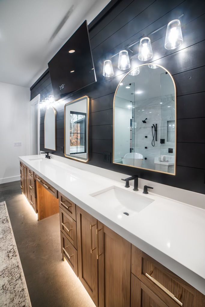 A bathroom with two sinks and two mirrors.