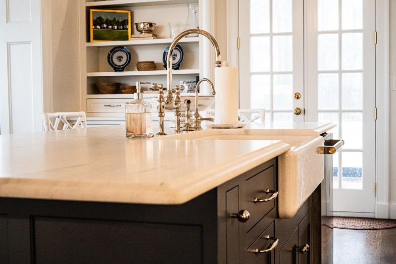 A kitchen with a sink and a faucet on the counter.