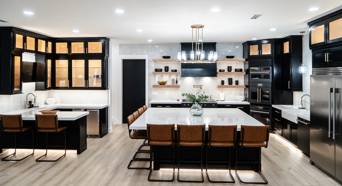 A large kitchen with a large island in the middle and stainless steel appliances.