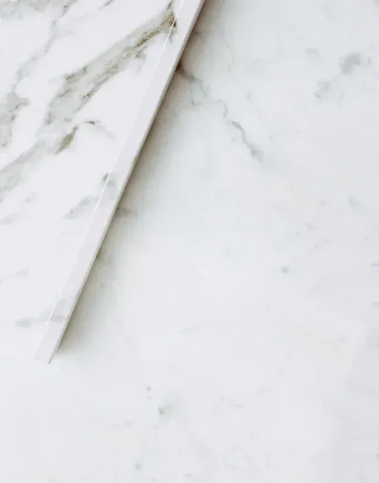 A close up of a piece of white marble on a table.