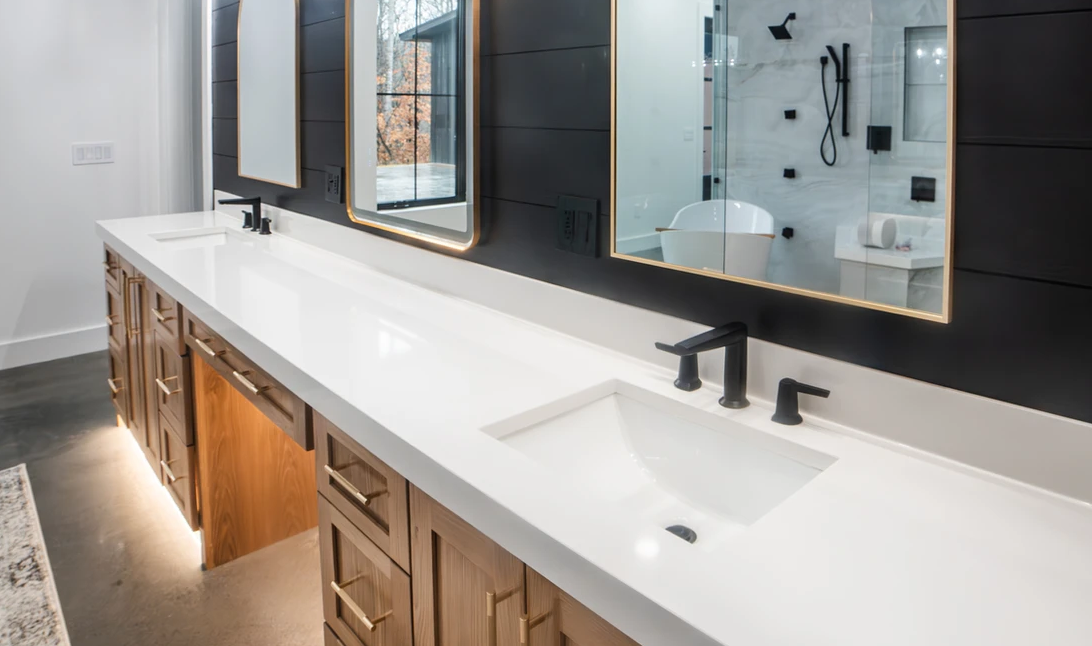 A bathroom with two sinks and two mirrors.