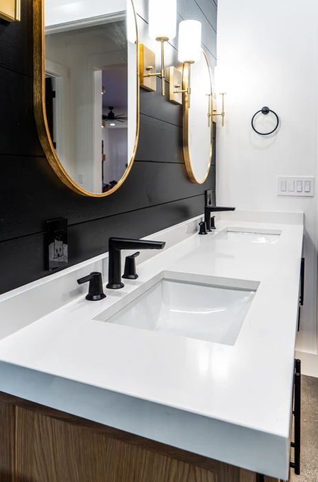 A bathroom with two sinks and two mirrors.