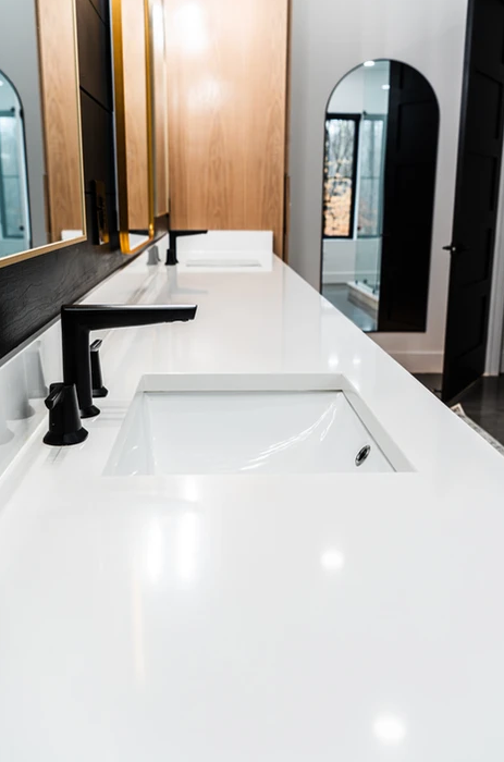 A bathroom with two sinks and two mirrors.