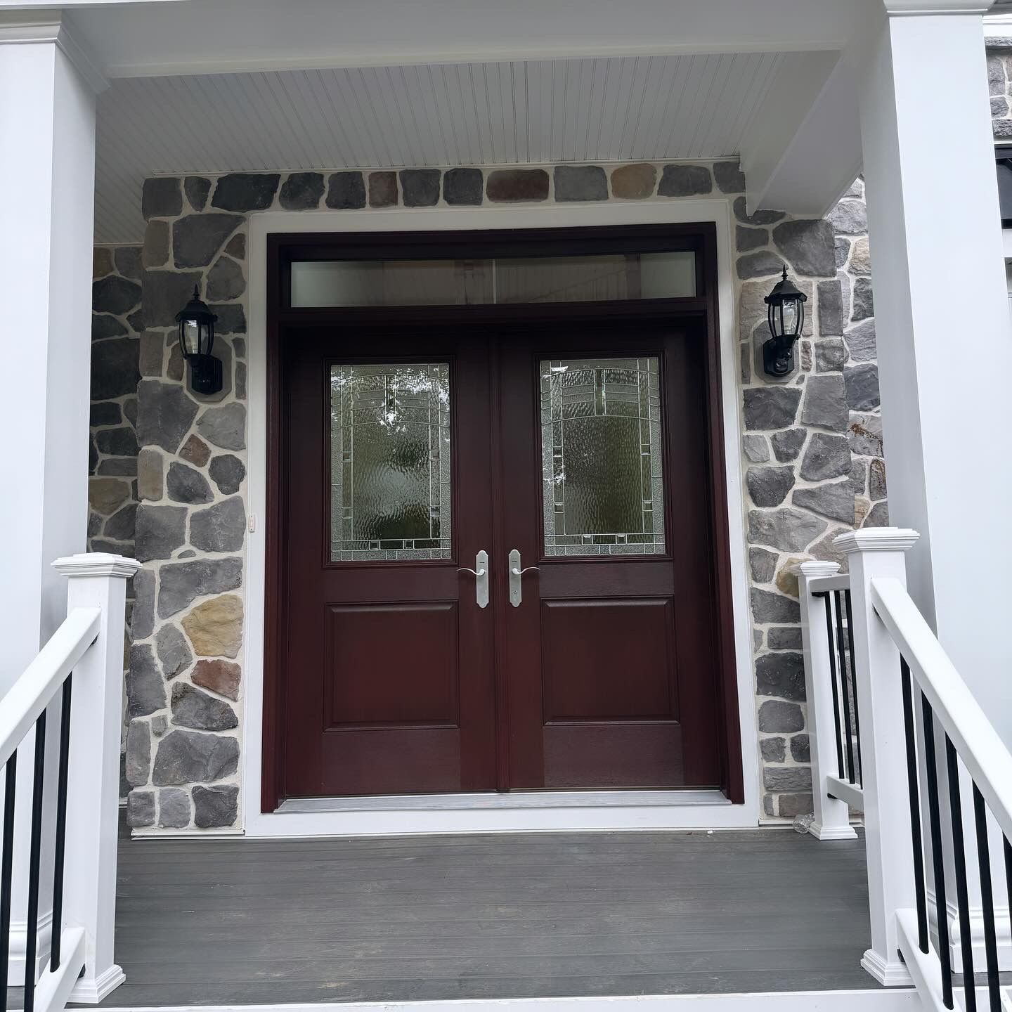The front door of a house with a stone wall