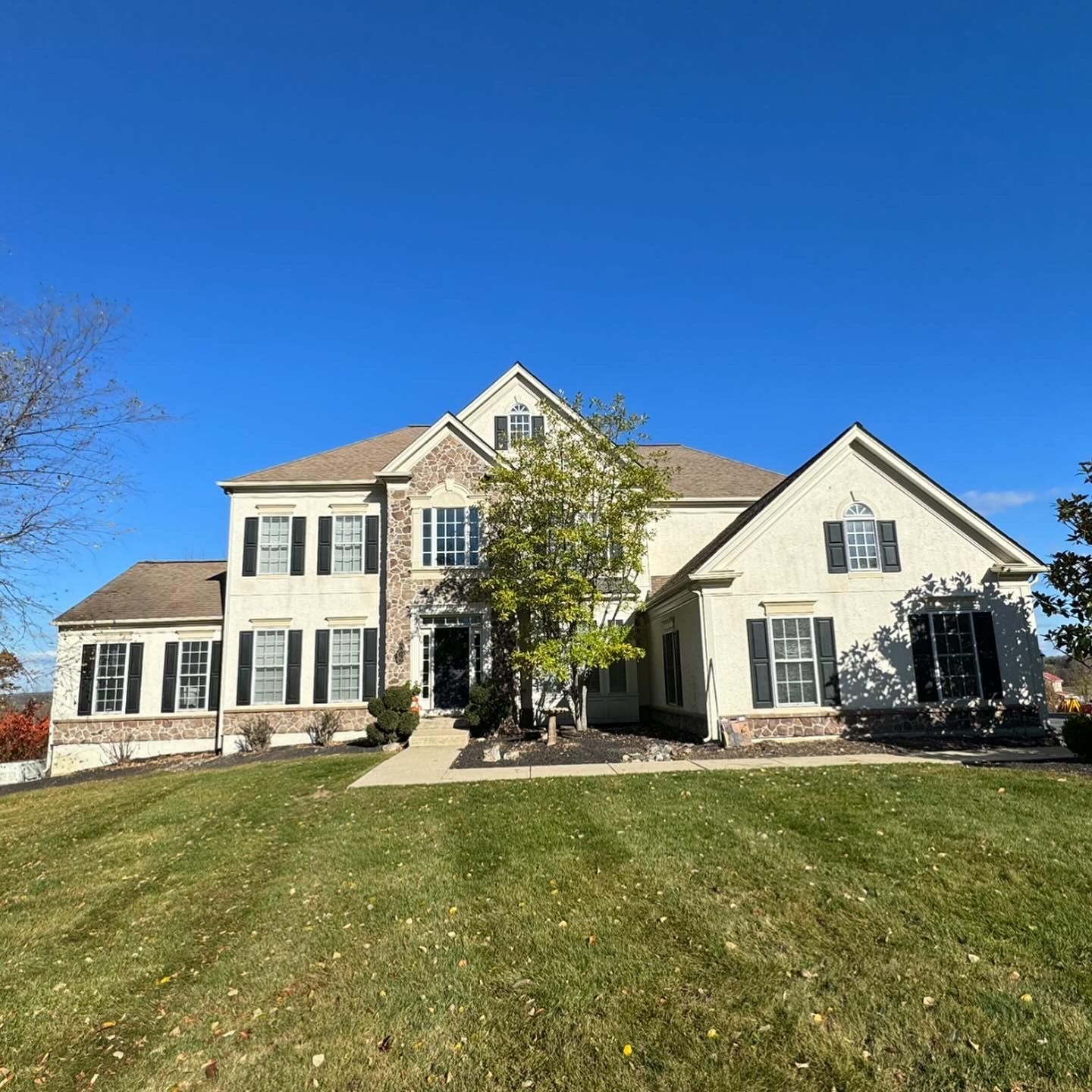 A large house with a lush green lawn in front of it