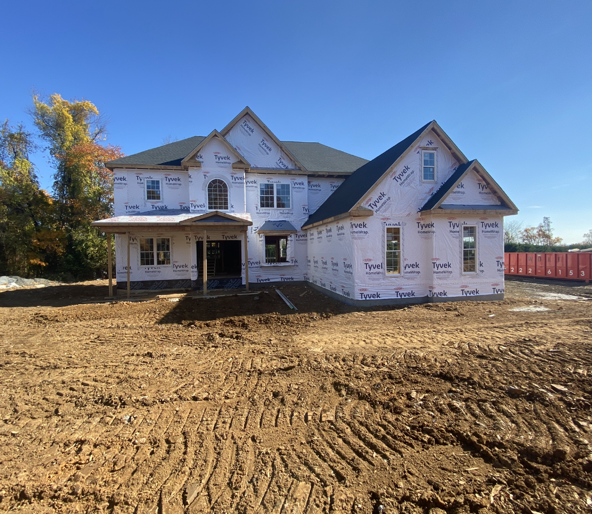 A house is being built in the middle of a dirt field