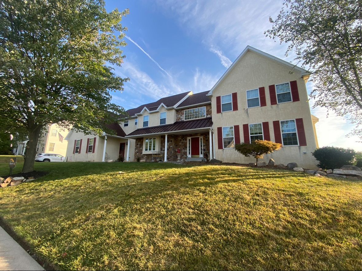 A large house with a large lawn in front of it.