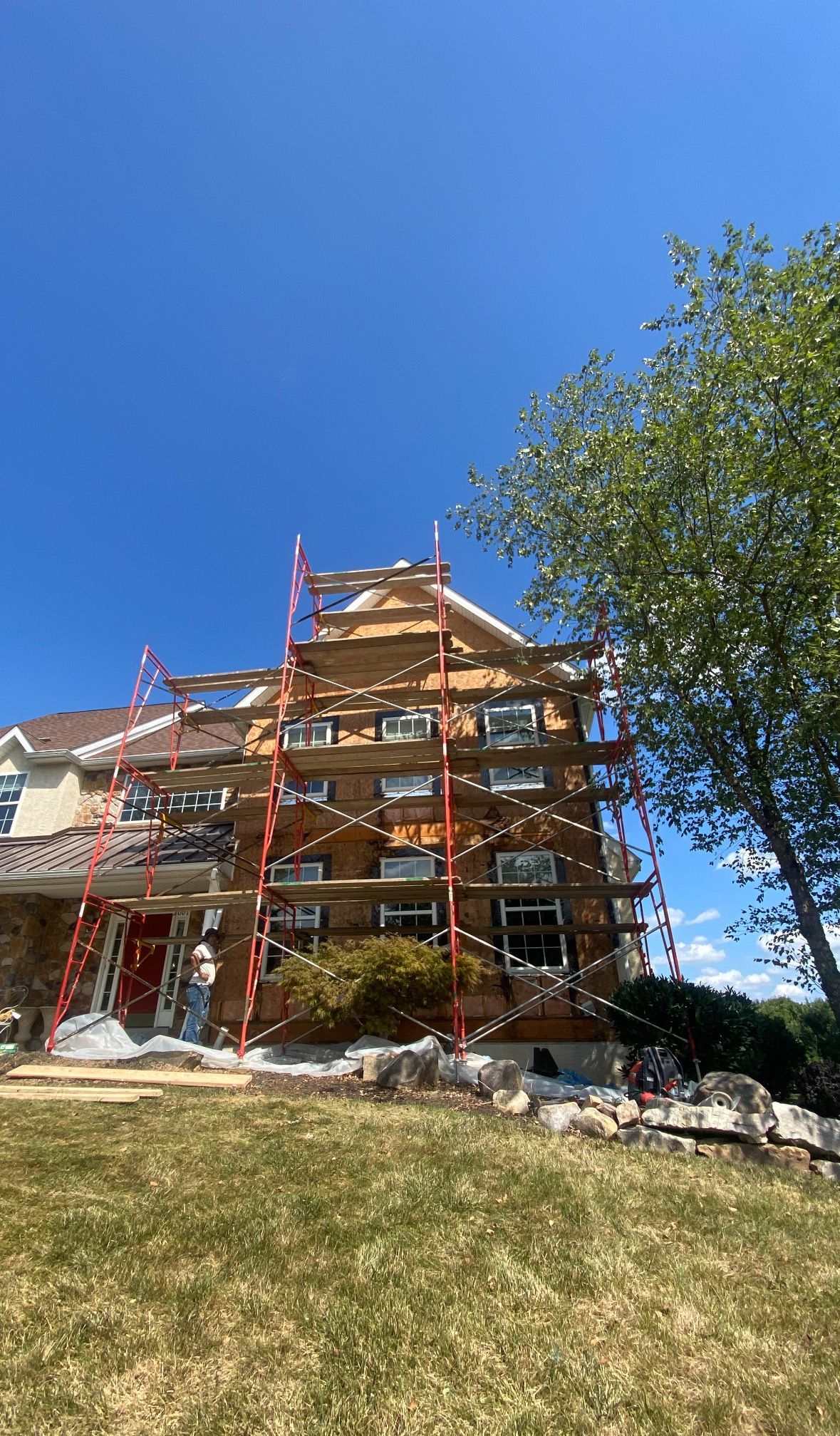 A large house is being built with scaffolding around it.
