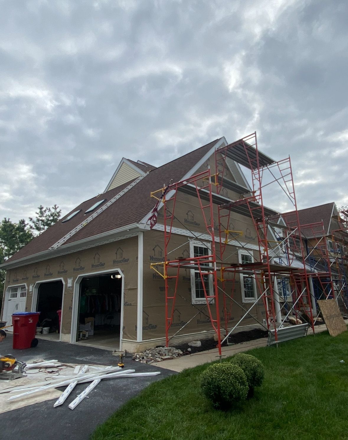 A house is being remodeled with scaffolding around it.