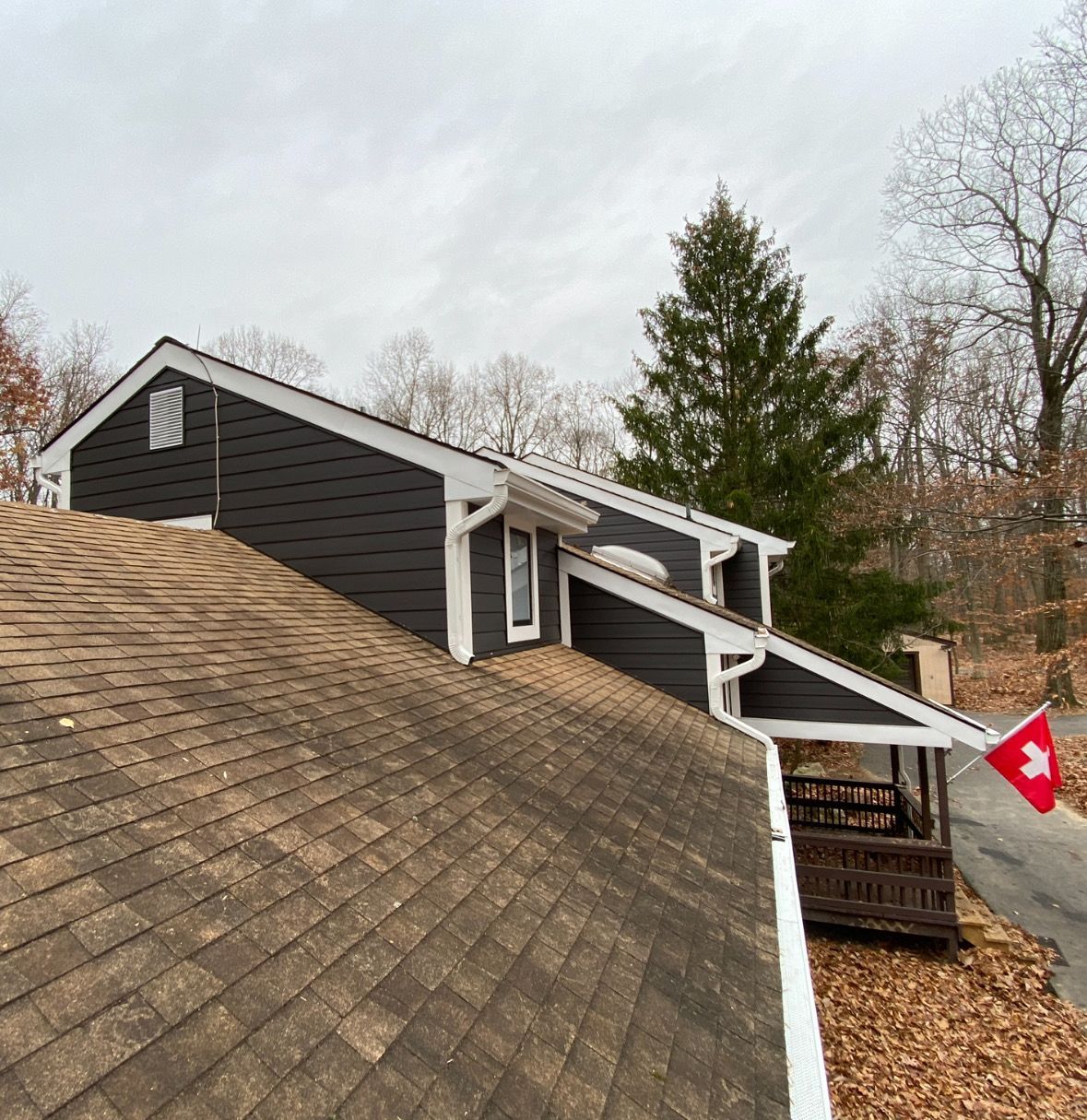 A roof of a house with a red and white flag on it