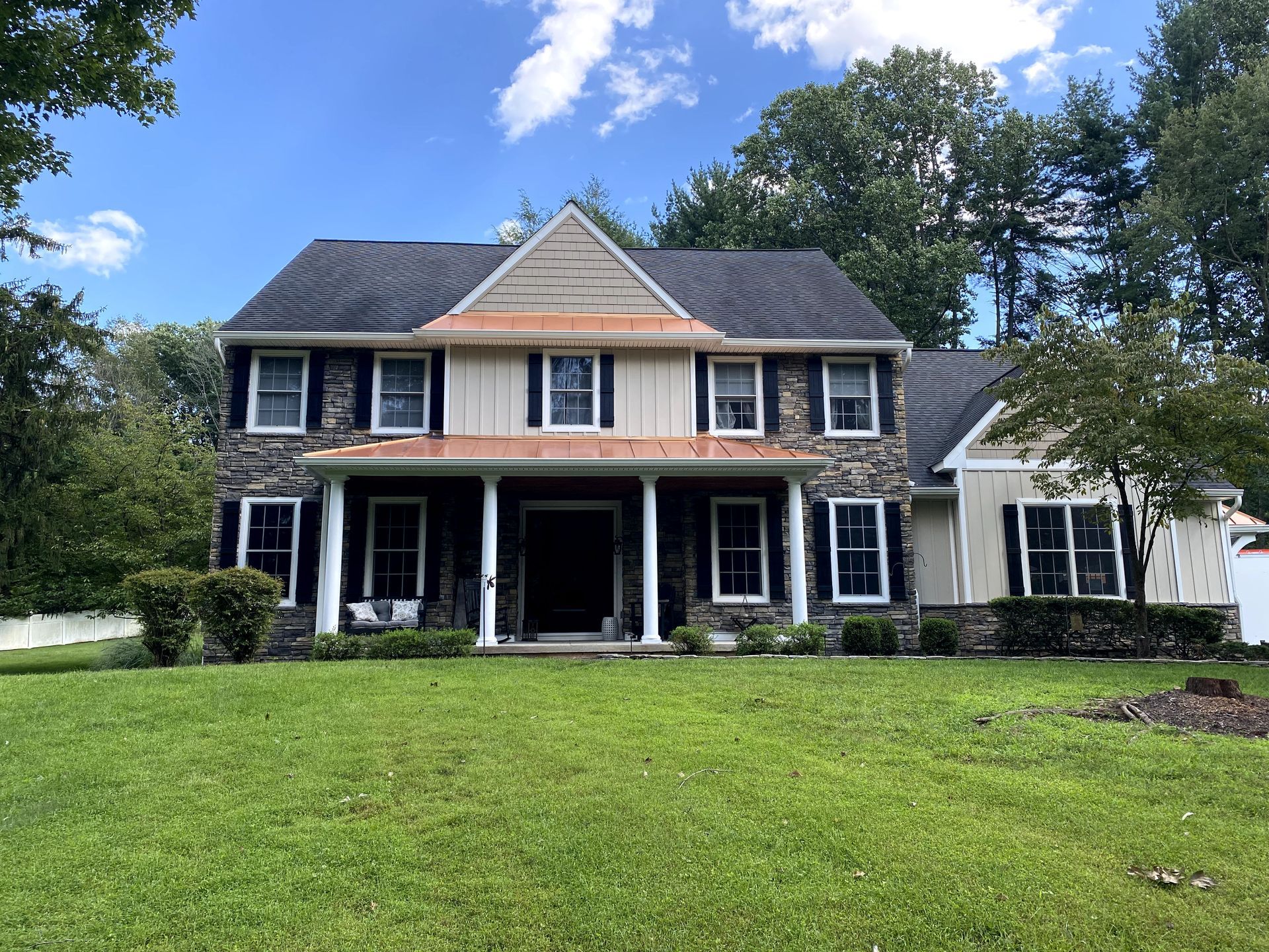 A large house with a large lawn in front of it.