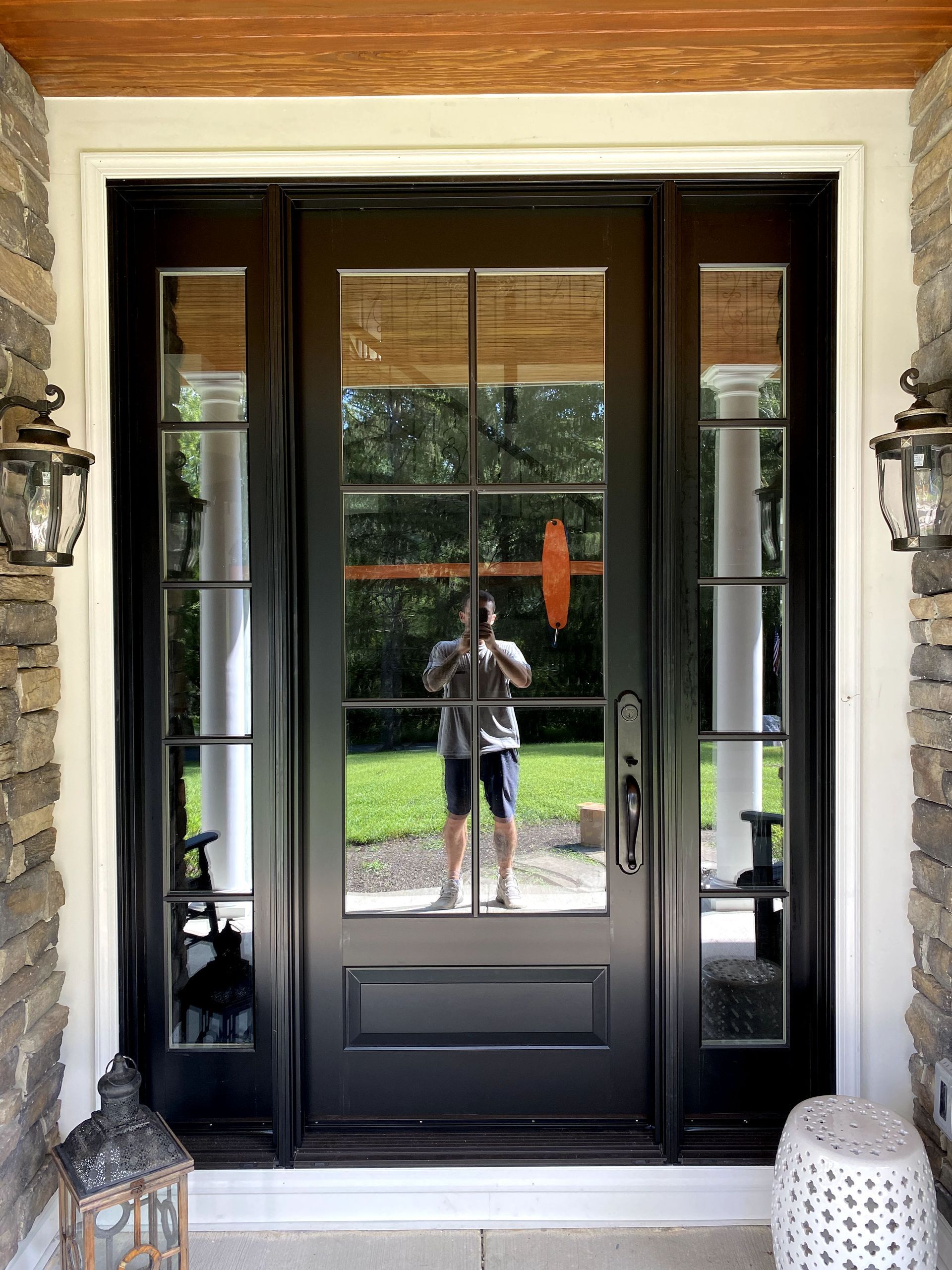 A man is taking a picture of himself in the doorway of a house.
