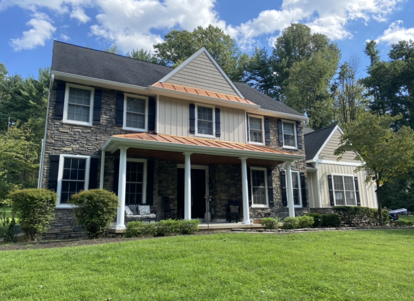 A large house with a large lawn in front of it.