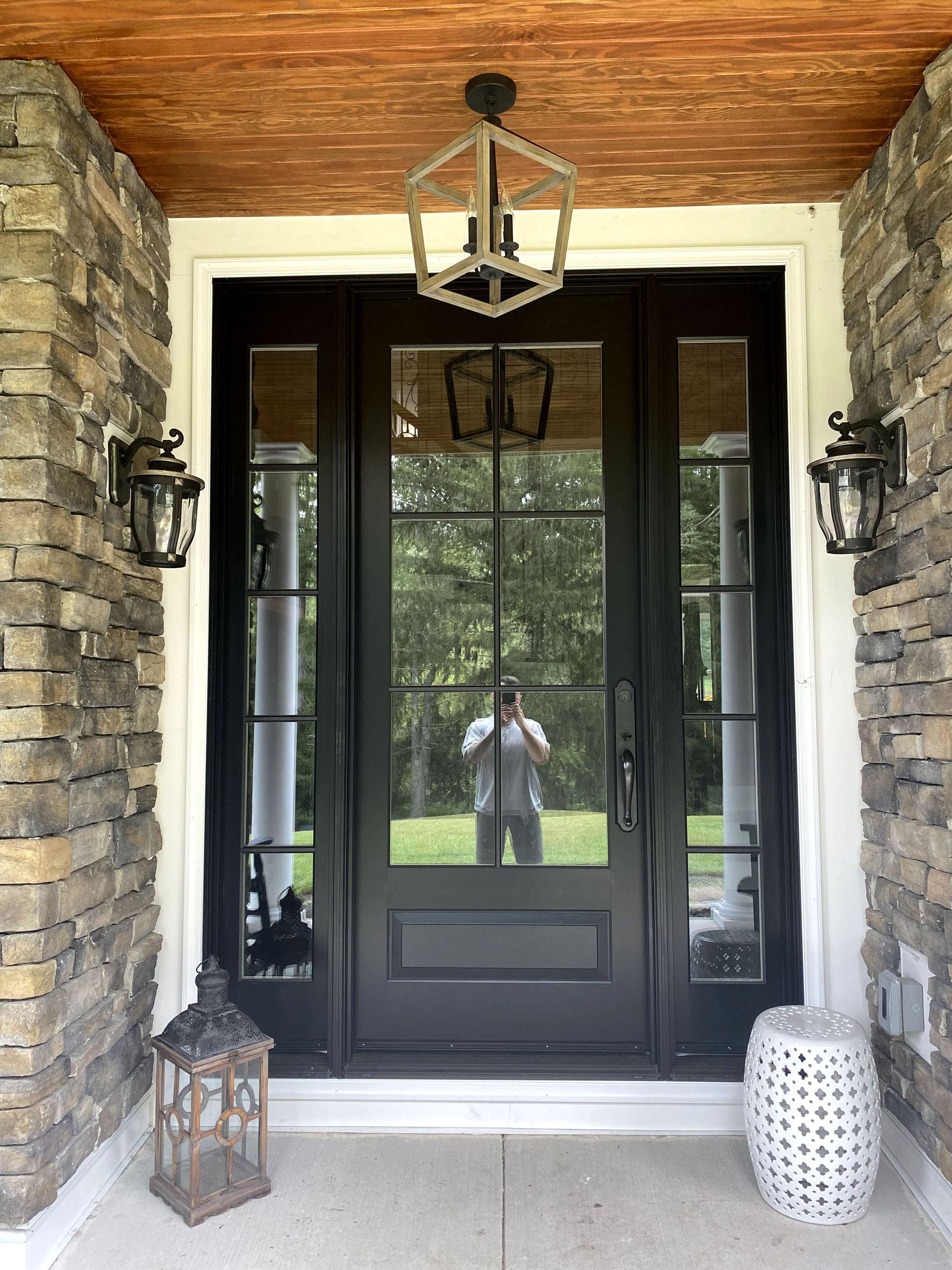 A man is taking a picture of himself in the doorway of a house.