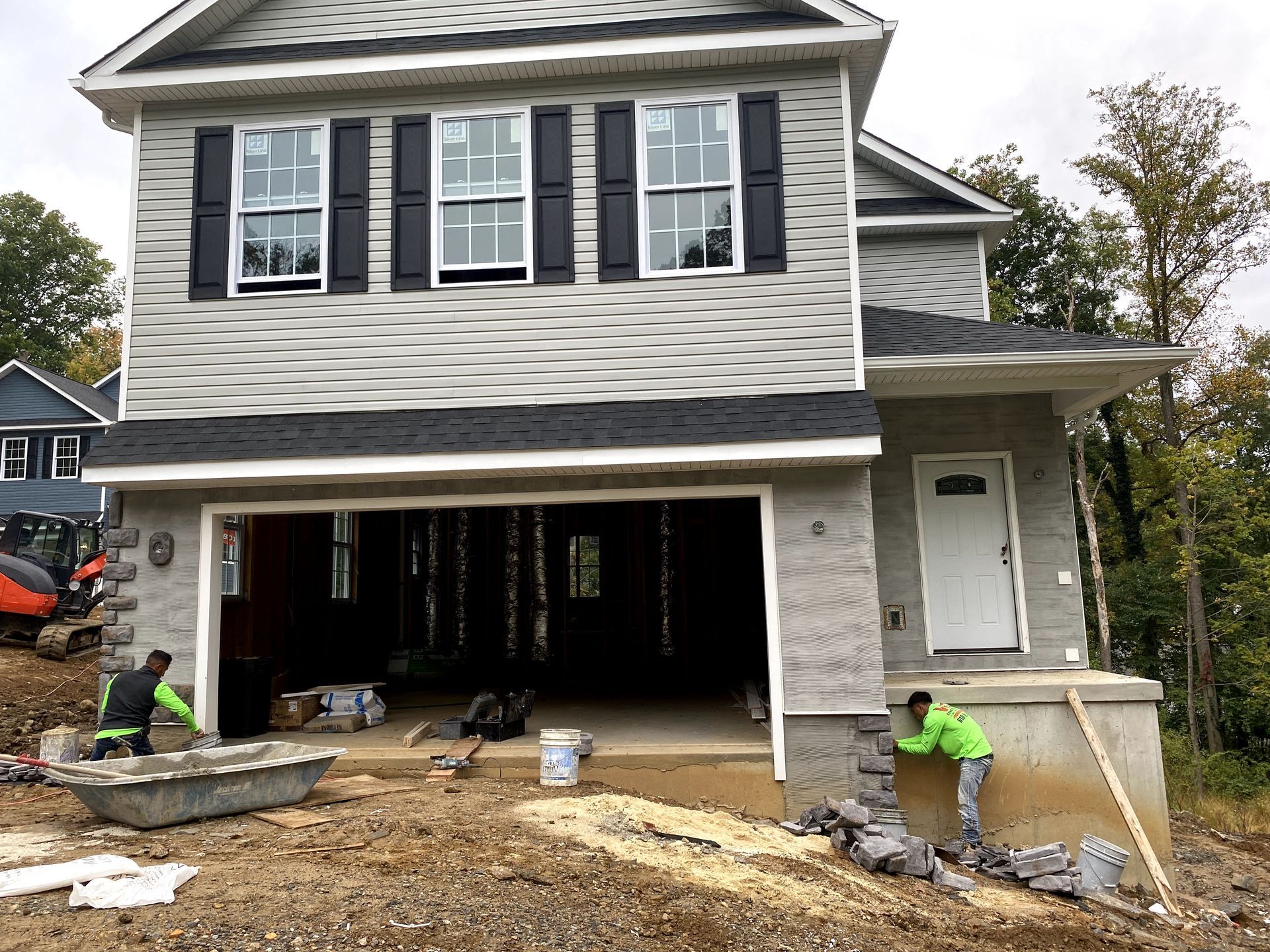 A house is being built with a large garage.