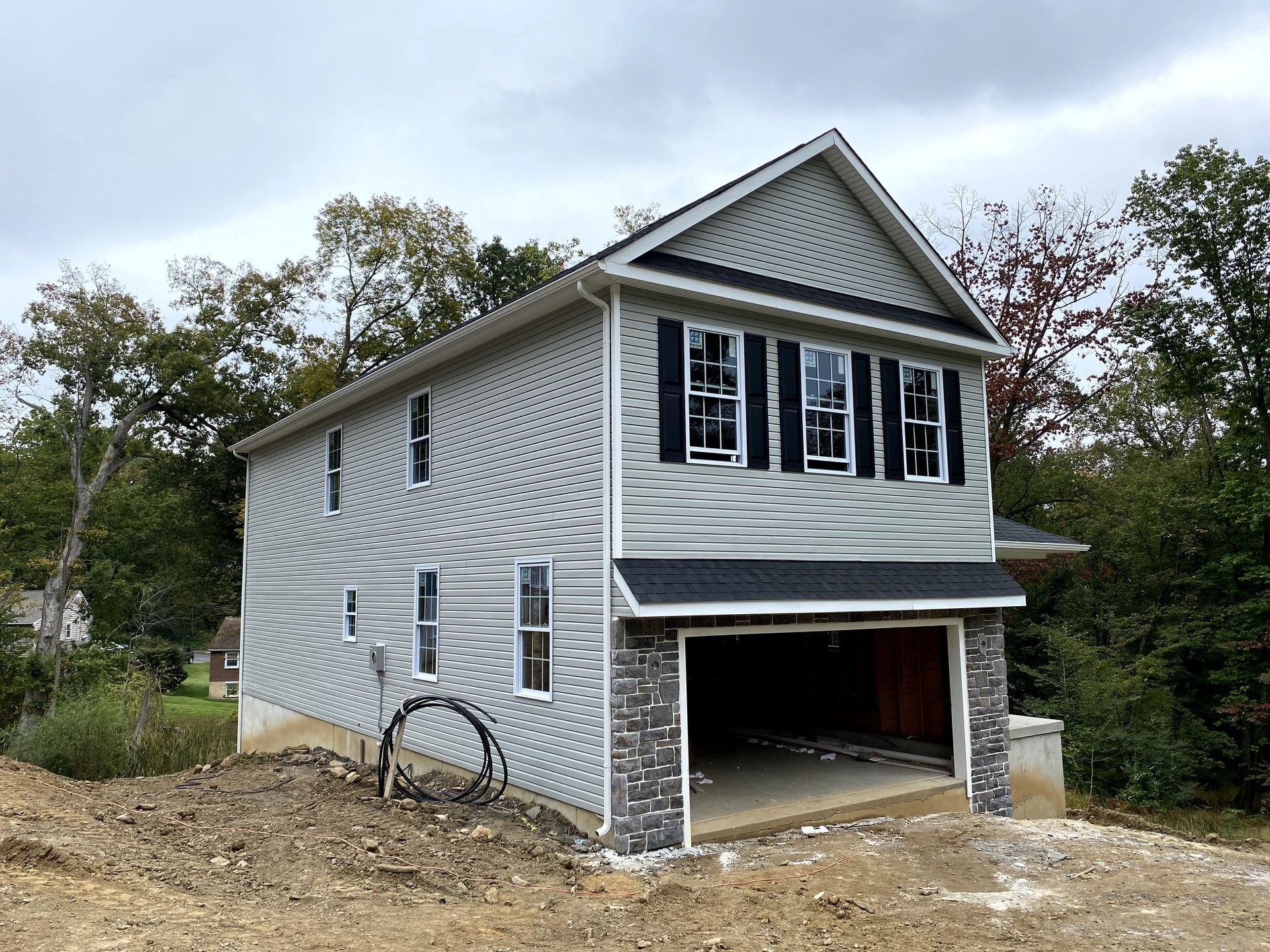 A house with a garage underneath it is being built.