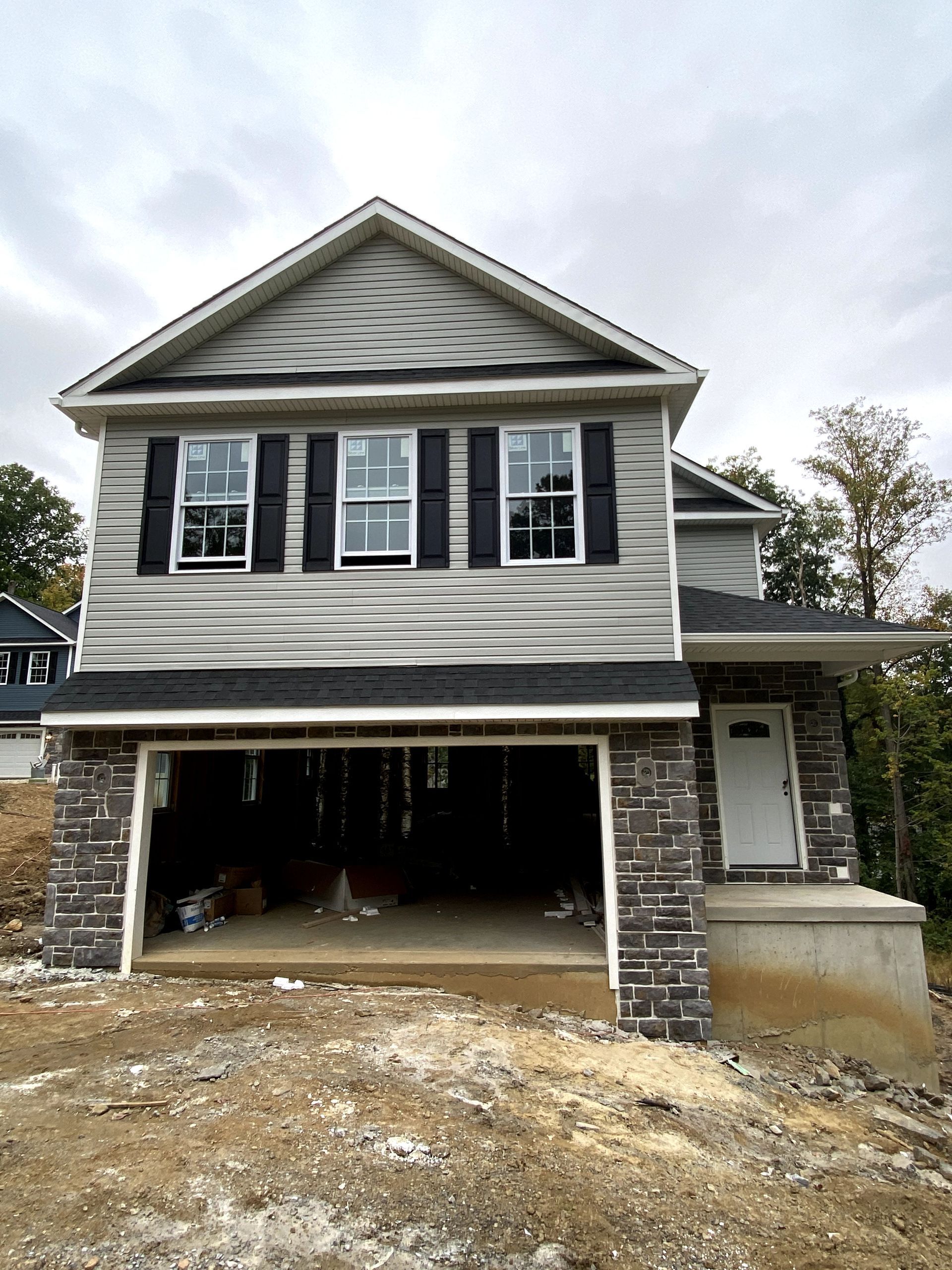 A house with a garage underneath it is being built.