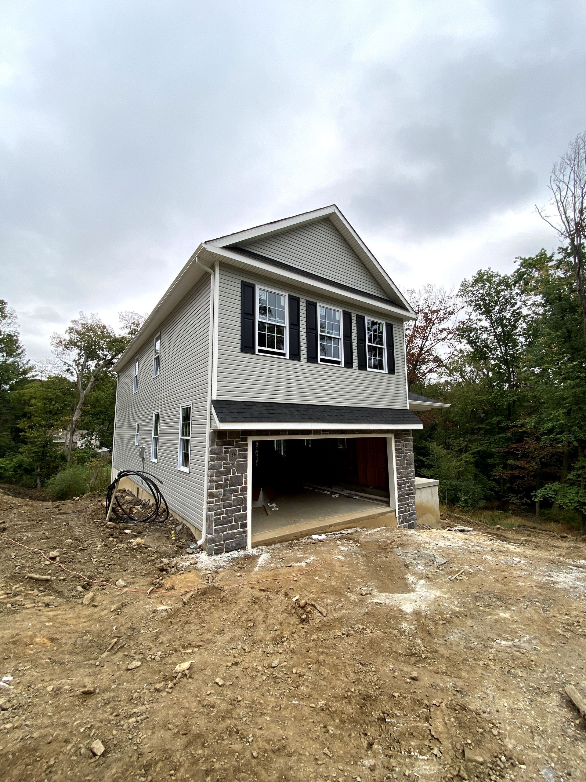 A house with a garage underneath it is being built.