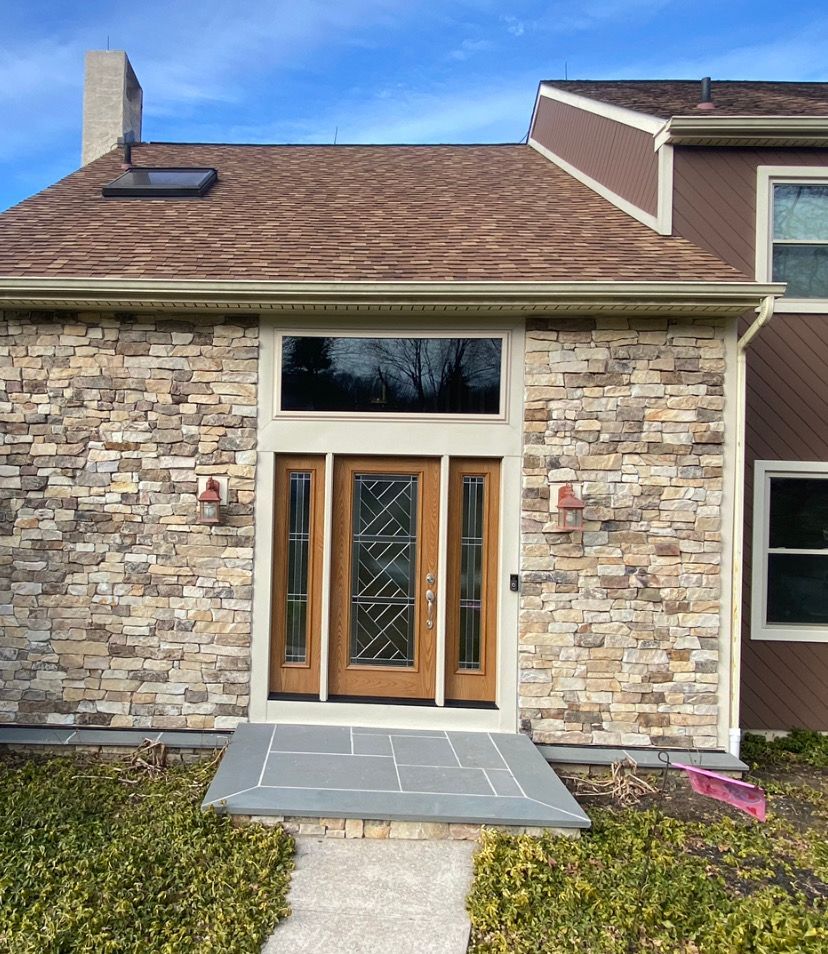 A house with a stone facade and a wooden door