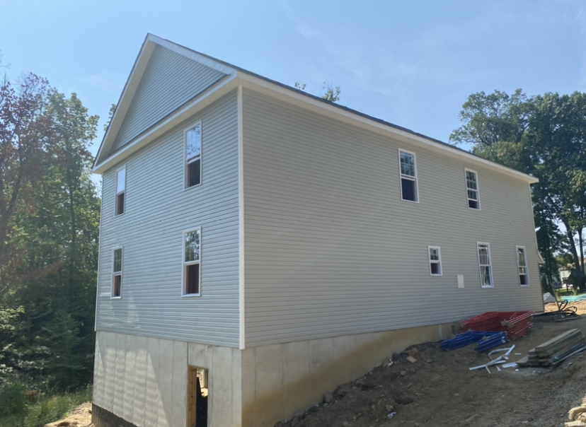 A house that is being built with a lot of windows