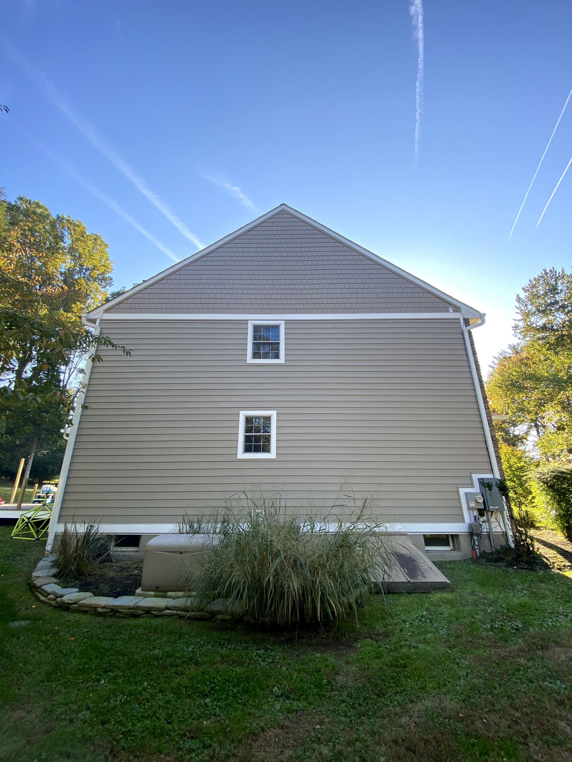The back of a house with a blue sky in the background.