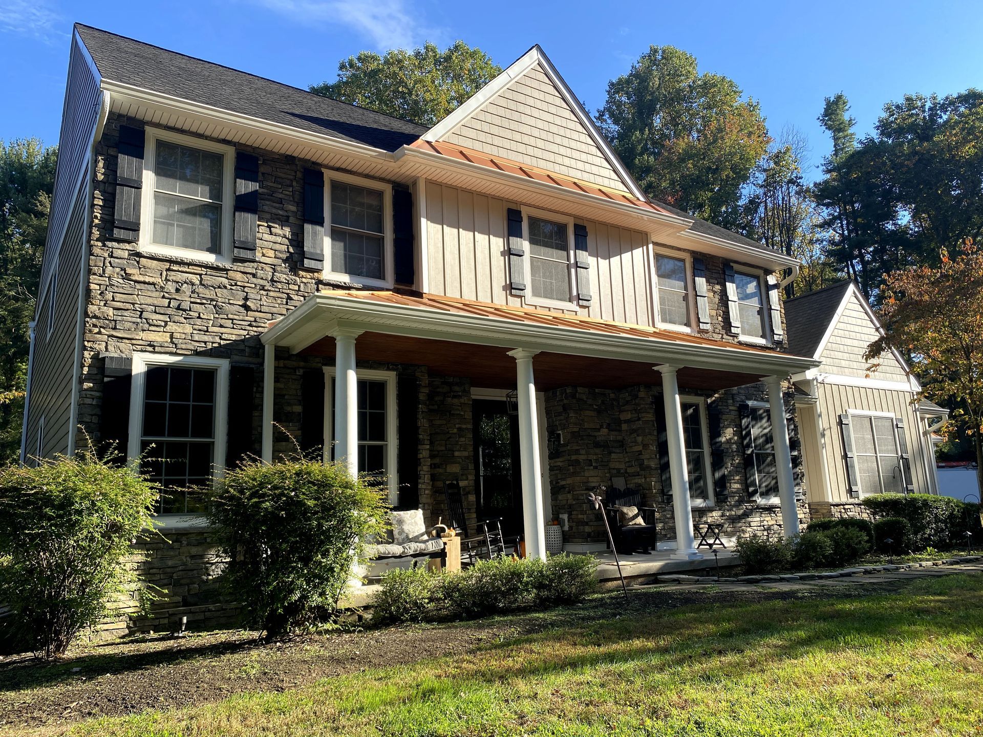 A large house with a large porch and a lot of windows