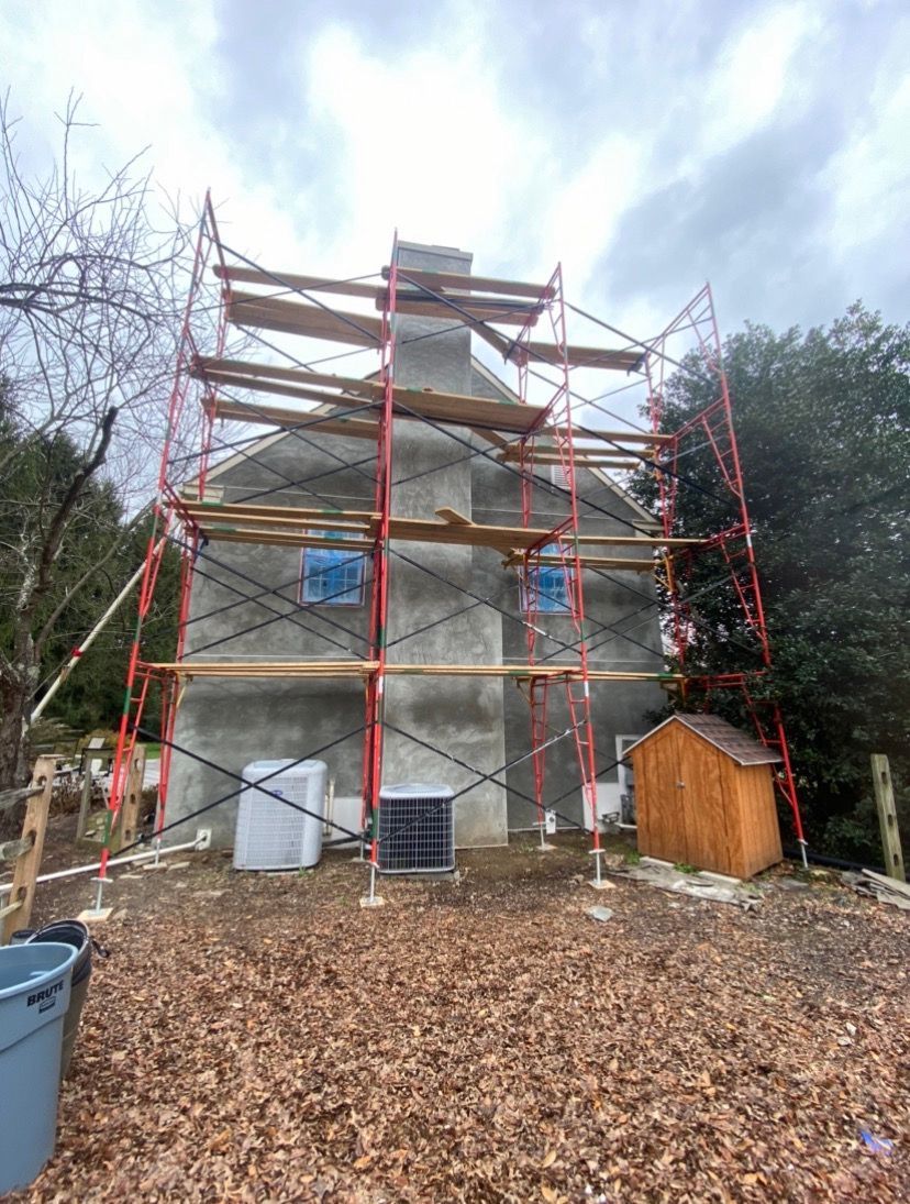 A house is being remodeled with scaffolding around it.
