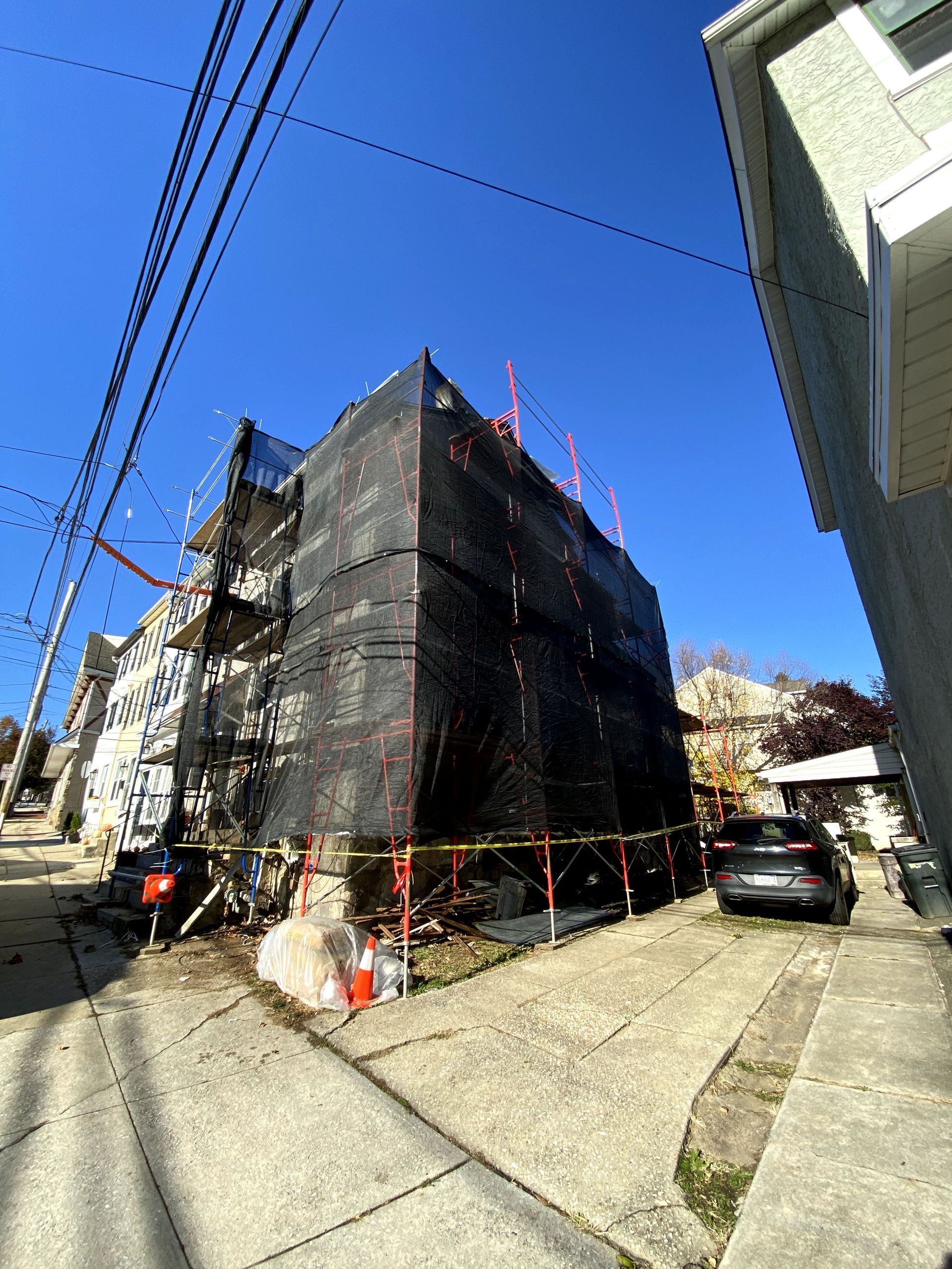 A large building is being built on the side of the road.