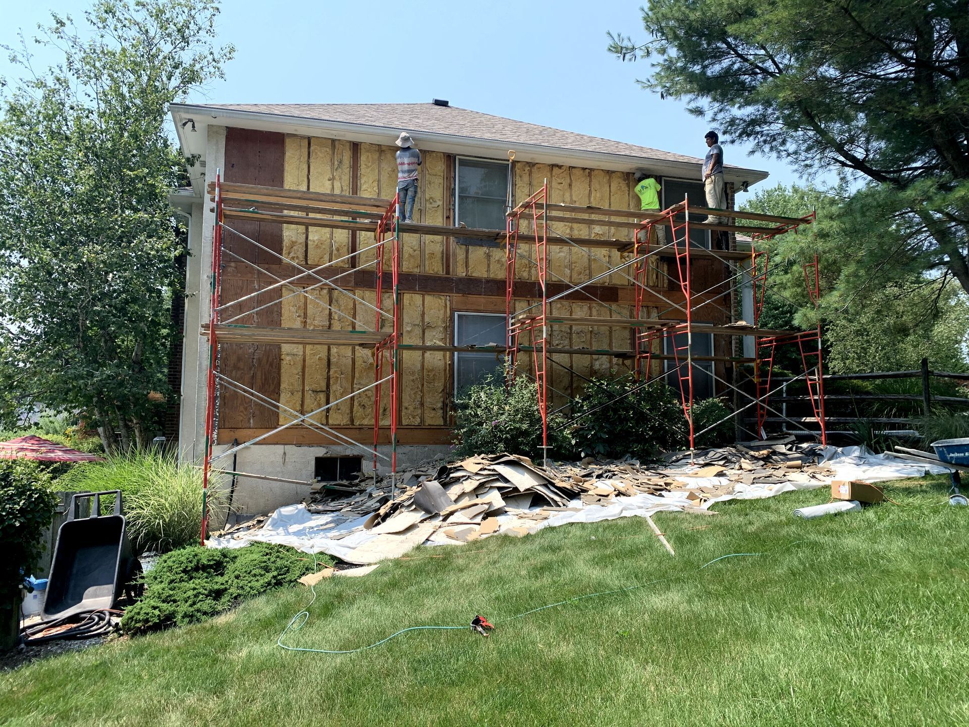 A house is being remodeled with scaffolding around it.