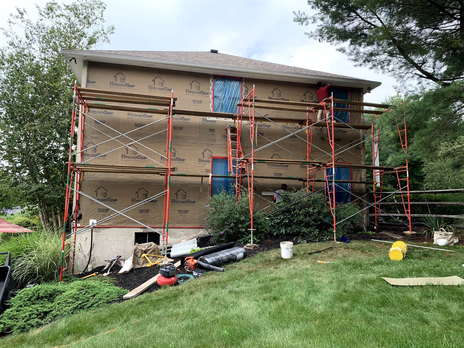 A house is being remodeled with scaffolding around it.