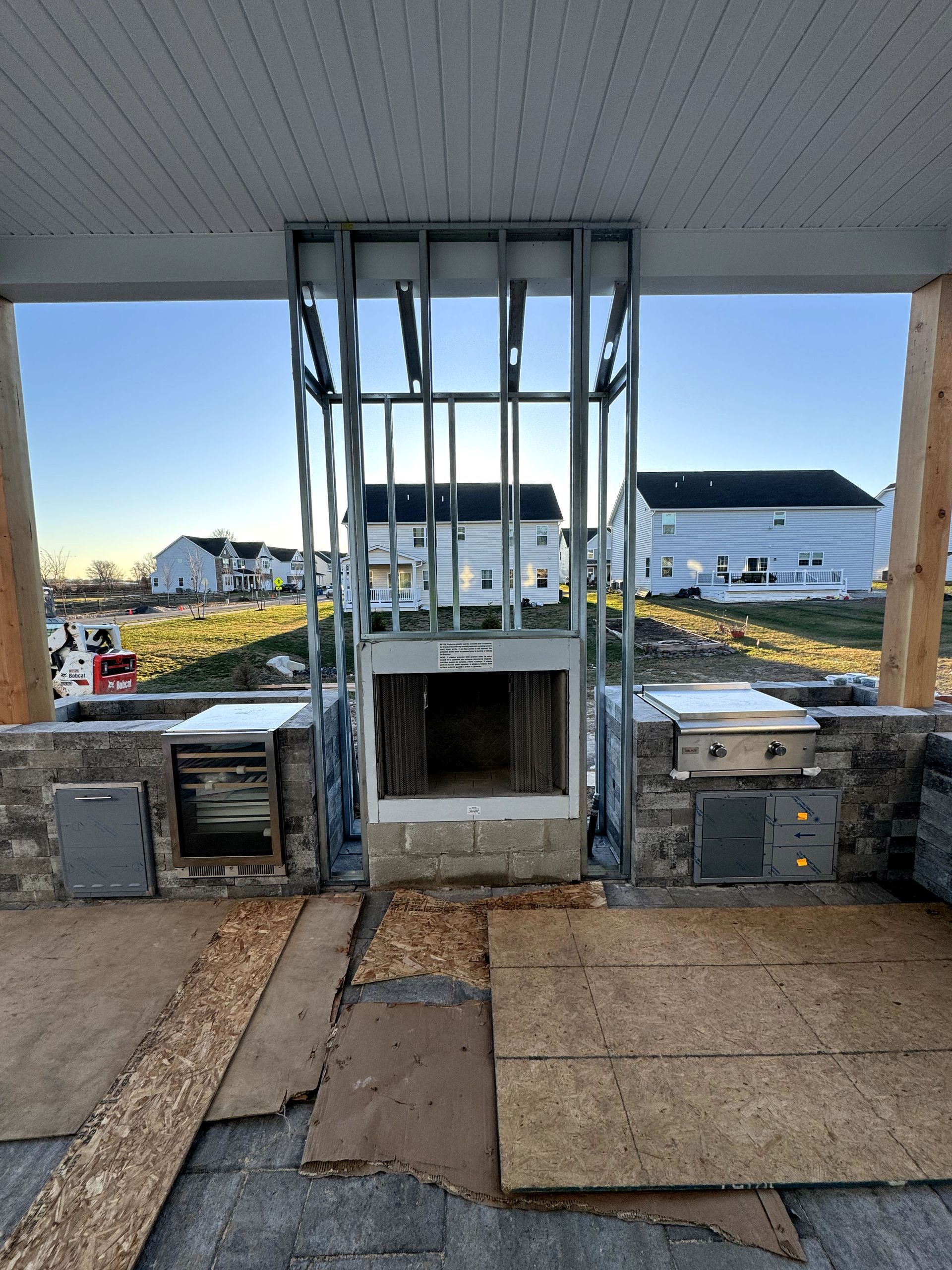 A fireplace is being built in a house under construction.