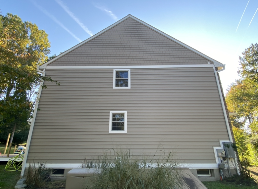 A large house with a lot of windows and a blue sky in the background.
