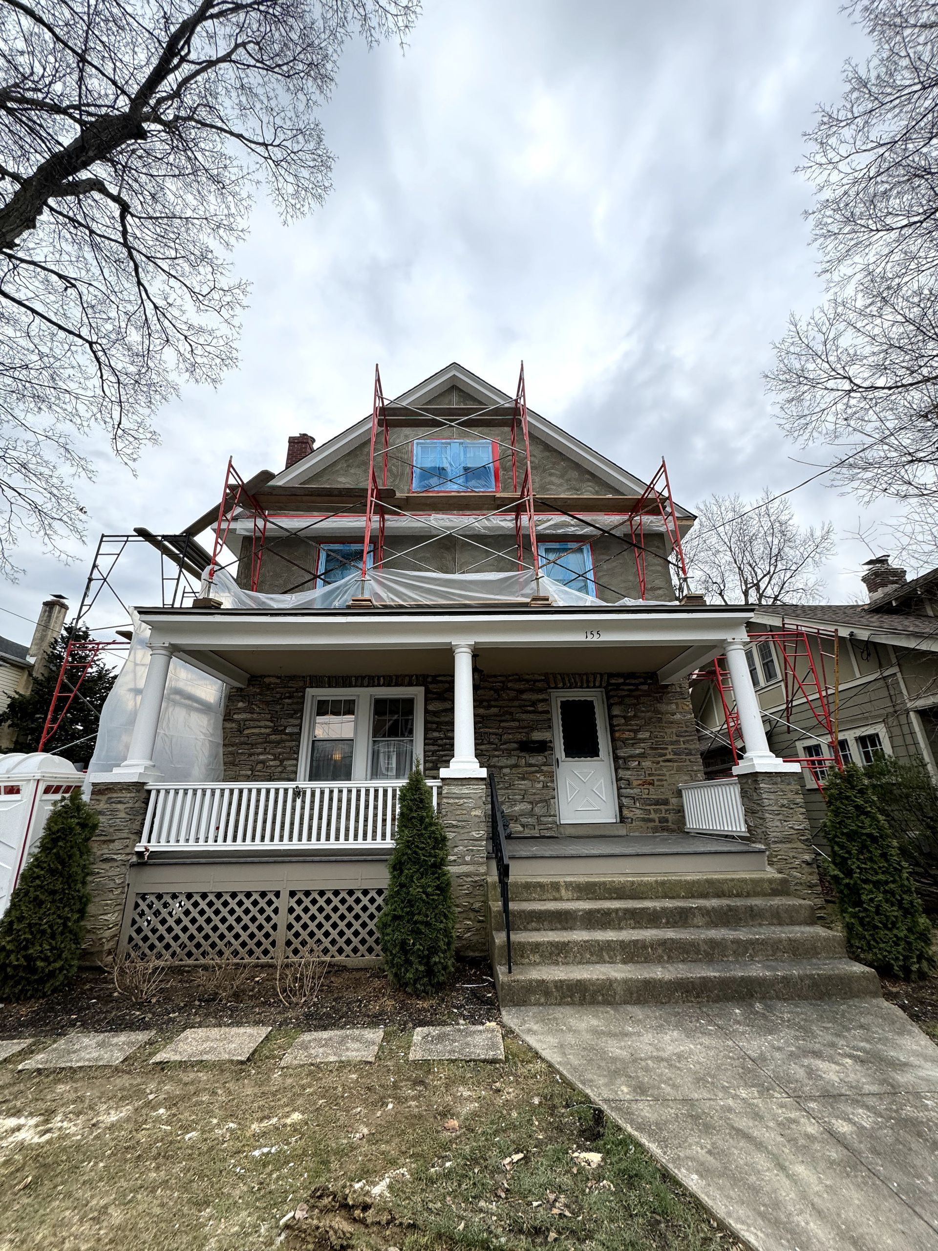 A house is being remodeled with scaffolding on the roof.