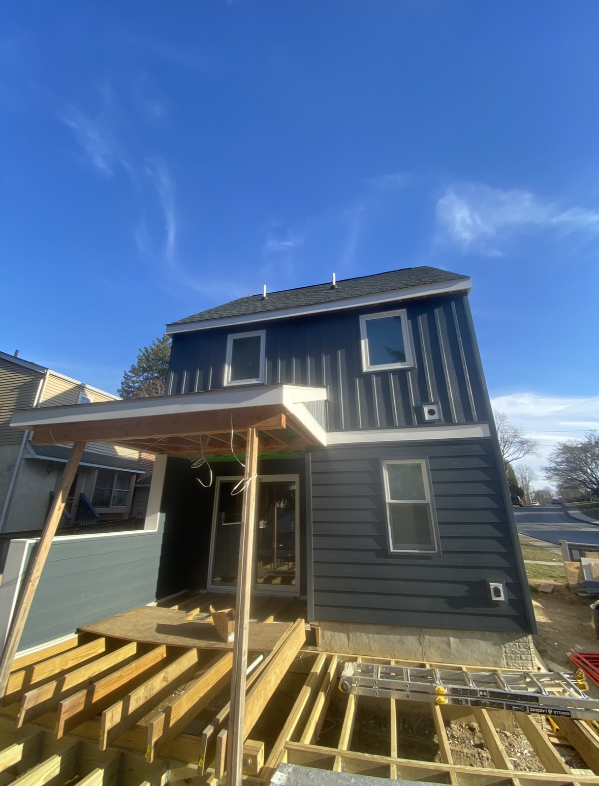 A house is being built with a wooden deck underneath it.