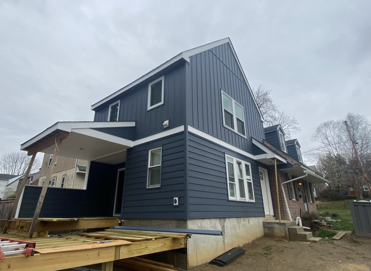 A blue house with a white trim is being built.