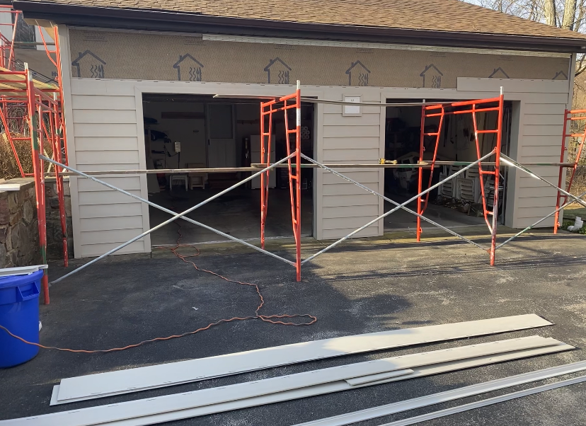 A garage is being remodeled with scaffolding around it.