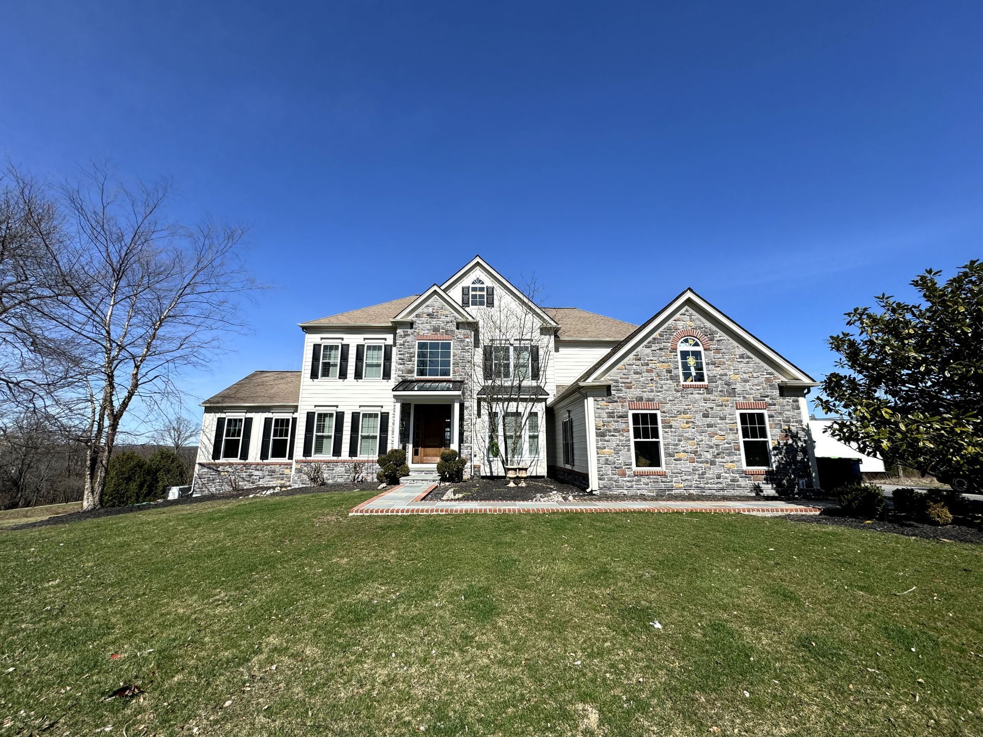 A large house with a large lawn in front of it.