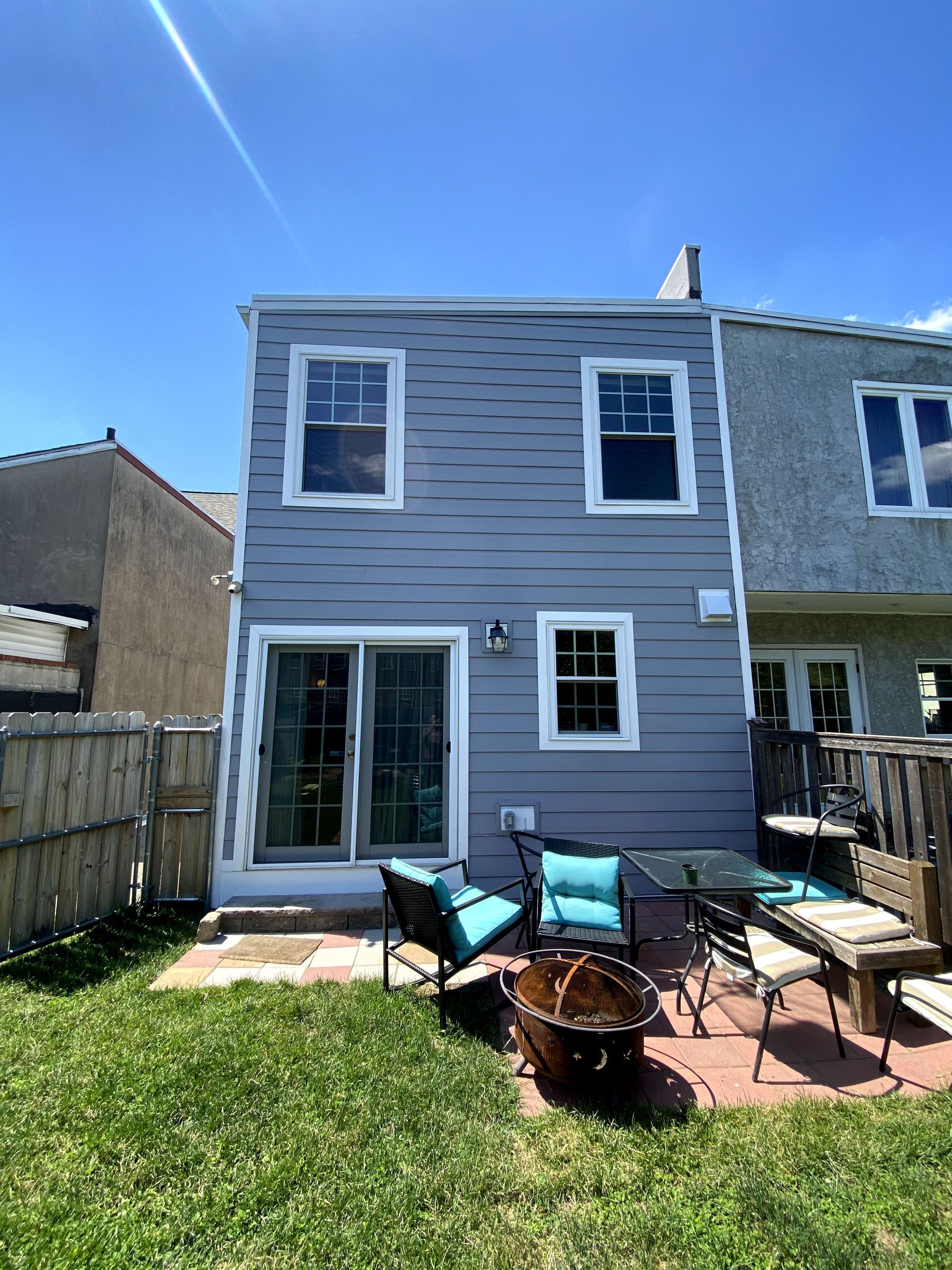 There is a fire pit in the backyard of a house.